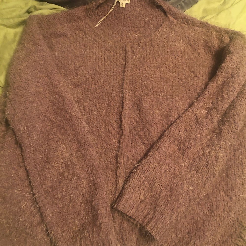 Distressed sweater in a dark rose/ mauve color